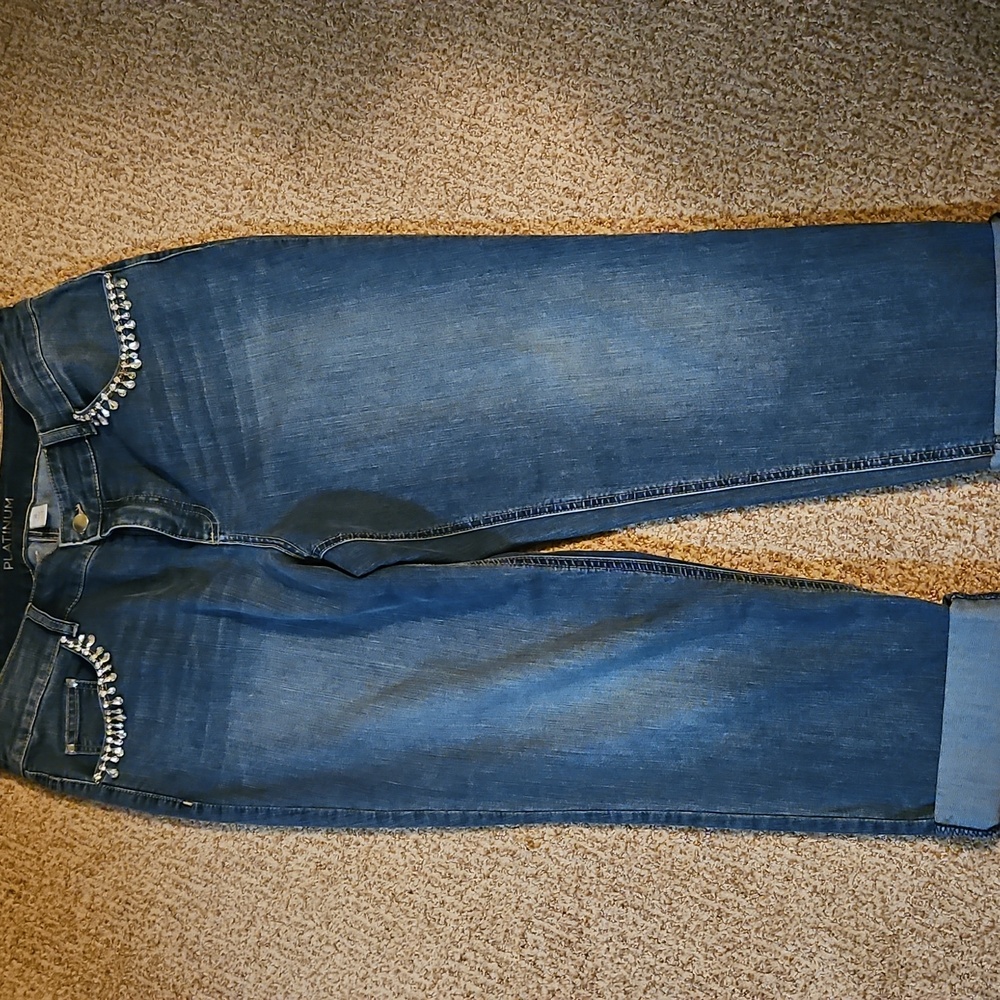 Chico's Platinum Light indigo faded jeans with rhinestone pocket details.